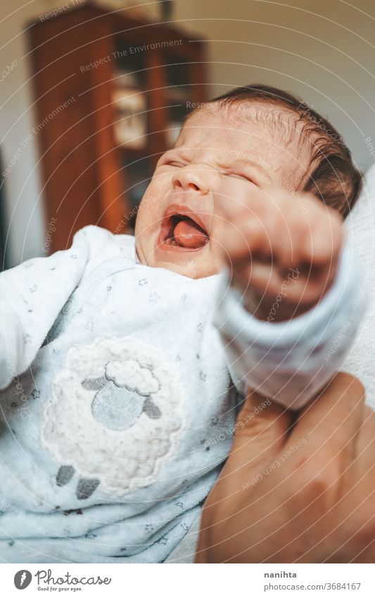Newborn baby really angry at home upset newborn huff tantrum cry crying screaming yawning signal discomfort girl boy kid daughter son pajama face expressive