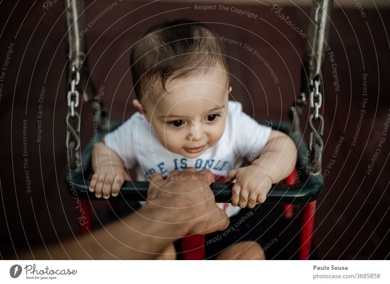 Father holding baby on the swing Swing Playground Together togetherness fatherhood Baby babyhood point of view Lifestyle family people Love care Parents