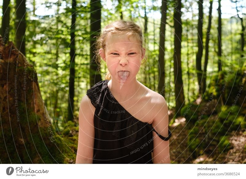 Wild girl in the forest sticks out her tongue Forest portrait Child Infancy Childhood memory Parenting Playing Exterior shot Joy Family & Relations Summer