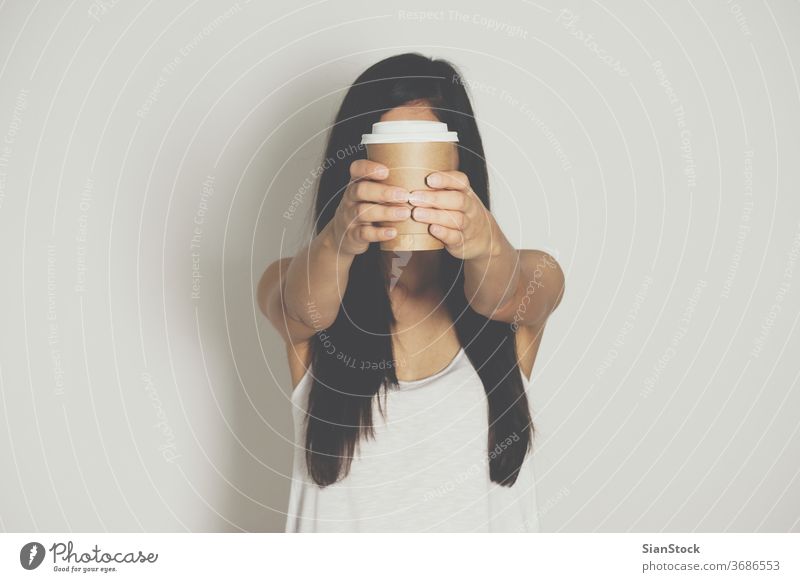Woman holding brown paper cup of hot coffee. isolated white drink hand woman background disposable cafe lid container caffeine breakfast icon design drinking
