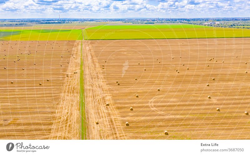 Aerial view of dirty road among agricultural fields Above Across Agricultural Agriculture Among Amongst Bale Between Border Cereal Confine Countryside Crop Dirt