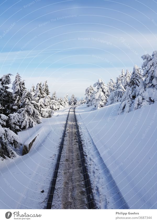 Winter rails snow covered winter wonderland train ride cold top of a mountain harz brocken deep snow white blue