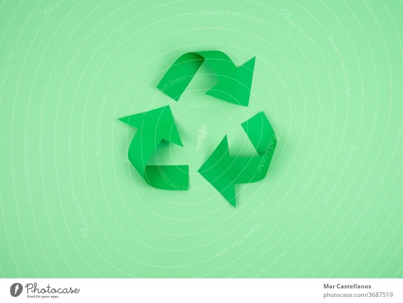 Recycling logo on paper on a green background recycling copy space ecology modern current clean company ecological icon concept symbol environment recycled