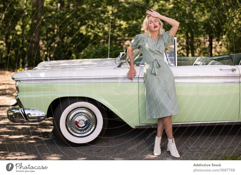 Charming blondie near retro car on street woman vintage style young vehicle classic lifestyle female trendy sunglasses transport fashion confident sensual auto