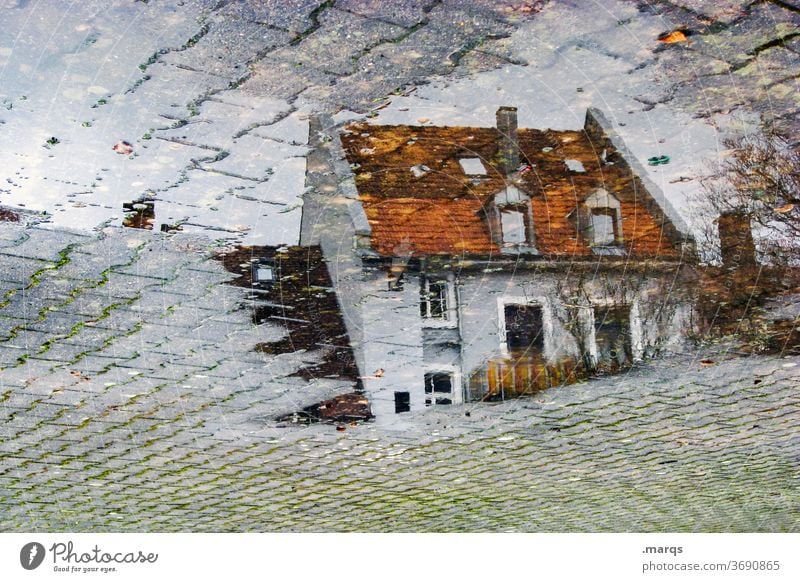 Residential house in puddle Wet Perspective Stone slab Autumn Reflection Puddle Apartment Building House (Residential Structure) Gray dwell optical illusion