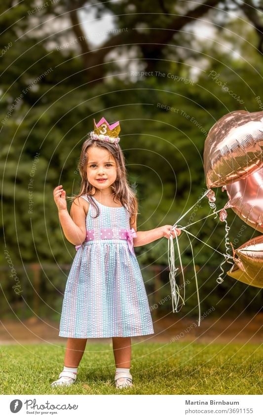 3-year-old birthday girl with her balloons outdoors child celebration cheerful childhood toddler cute kid adorable daughter present family pretty surprise