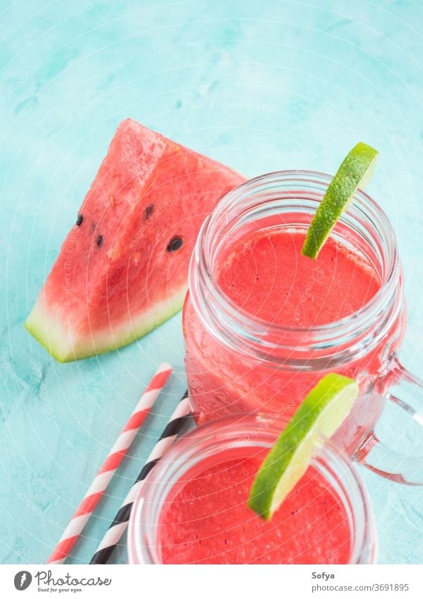 Watermelon smoothie with lime and mint watermelon summer drink green blue turquoise red beverage juice cocktail fresh cold straw berry mason jar glass citrus
