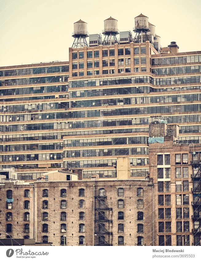 New York old buildings, retro colouring applied, USA. Water Tower Tank built Retro Vintage City Old NYC Instagram effect Window Brick fire escape filtered