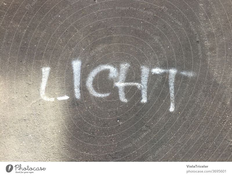 Light: sprayed lettering on asphalt Asphalt Street Sprayed White Gray Ground floor out daylight Shaft of light Handwriting Typography typo Word Bright spot