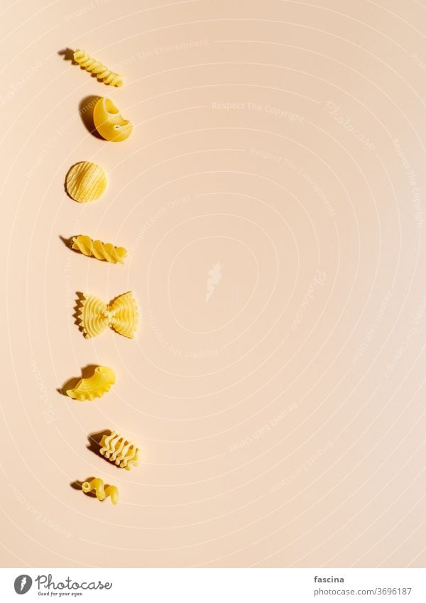 Different pasta on cream background, copy space assortment different art macaroni creative layout top view flat lay top down menu concept recipe delicious tasty