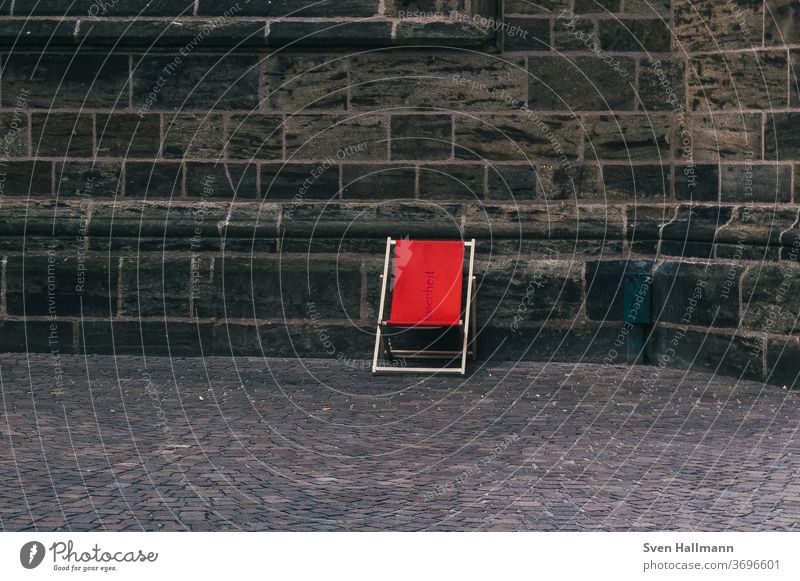 red chair in front of a wall minimalism Port area Abstract Decompose Chair urban uster Magic wand White Red Seating Empty chairs from Summer Furniture Deserted