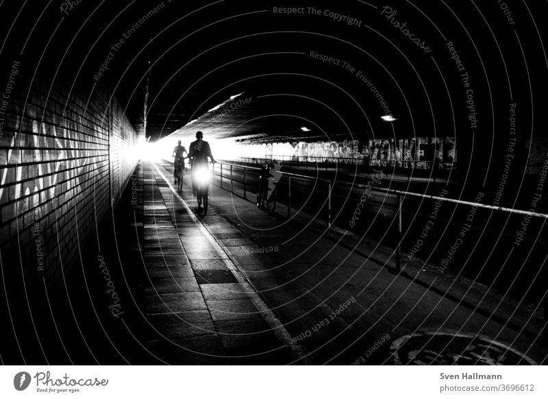 Cyclists in the tunnel Transport City Speed Exterior shot Driving Trip Shadow play Street urban Lifestyle Cycling Movement Art Sports cyclists tutorial Bicycle