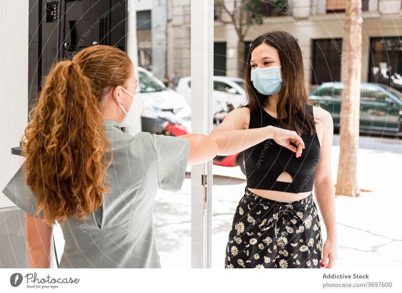 Specialist of spa salon greeting client with gesture during coronavirus pandemic protect prevent new normal mask women entrance patient staff meeting