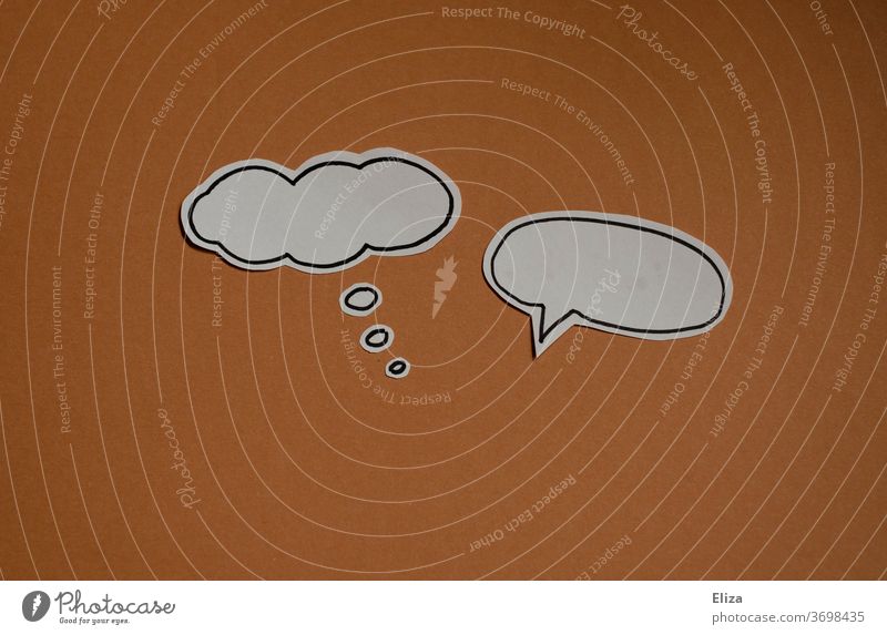Opposites | thought bubble and speech bubble on brown background. Thinking and speaking. Communication. communication To talk antagonism say and mean disparate