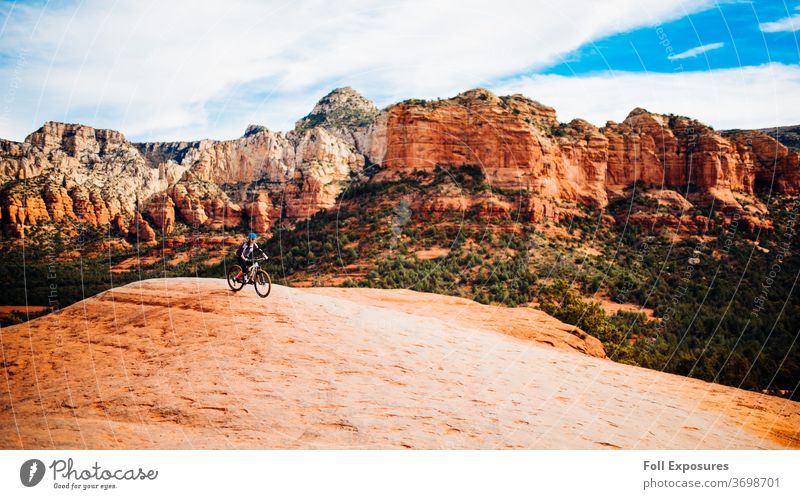 Mountain biker rides through beautiful red rock country of Sedona, Arizona sedona arizona az cliff cliffs mountain bike mountain biking rider downhill
