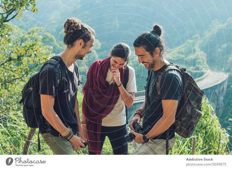 Happy diverse travelers having fun during journey in nature bridge friend active jungle hiker backpacker group photo camera forest activity tourism sri lanka
