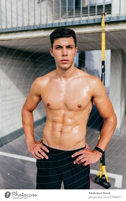 Strong sportsman with sweaty body on street muscular training workout strong shirtless male athlete healthy fitness wellness confident power sportswear