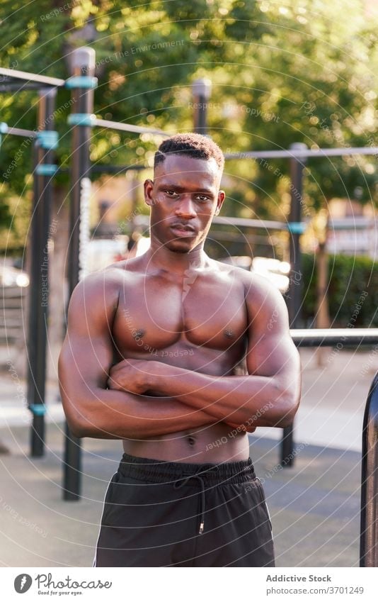 Black male athlete on sports ground sportsman muscular body training relax break determine naked torso ethnic african american black physical power motivation