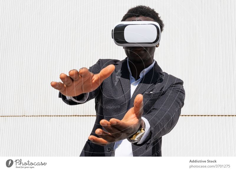 Black businessman in VR headset virtual reality vr using goggles male ethnic black african american innovation digital simulate cyberspace modern glasses device