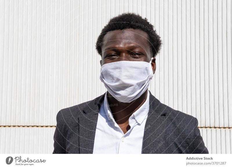 Cheerful black businessman in protective mask coronavirus pandemic covid cheerful entrepreneur formal portrait positive street young african american ethnic