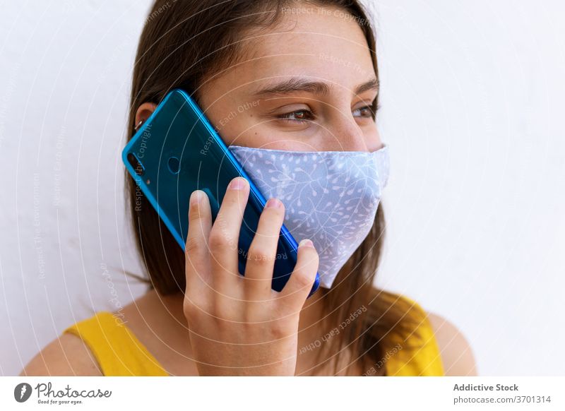 Woman in mask talking on smartphone woman medical coronavirus city discuss using epidemic female street mobile conversation call communicate device gadget