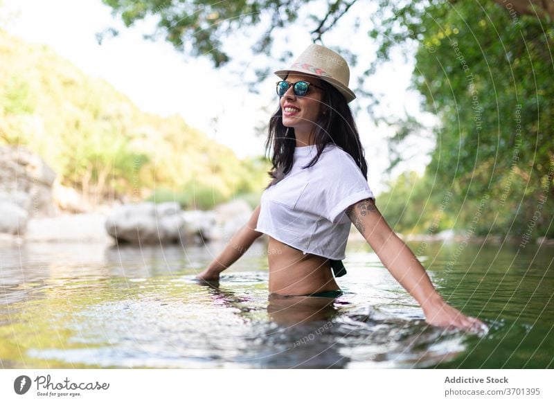 Calm woman in lake in summer forest travel enjoy vacation water pond relax female traveler carefree trip calm tourism holiday tranquil nature idyllic green
