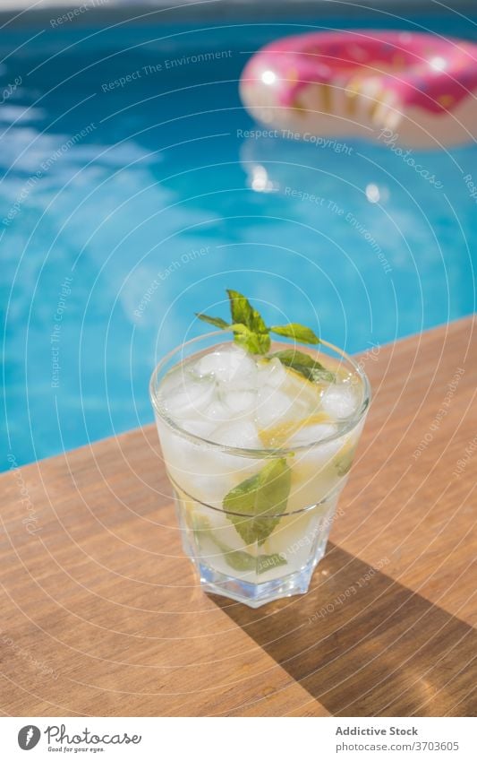 Glass of Mojito cocktail near swimming pool mojito drink alcohol ice lemon mint glass cold beverage citrus refreshment fruit cool tasty delicious gourmet serve