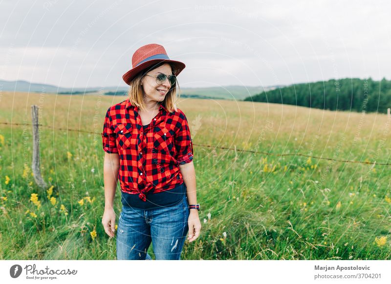 Portrait of a young casual woman in the field adult background beautiful beauty blonde carefree caucasian cheerful cute enjoy farm farmer fashion female freedom