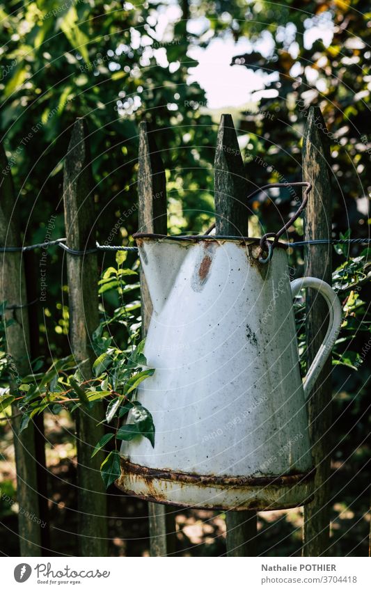 Old jug hanging on the wooden fence pot can vintage outside farm farmer country beverage health rustic rural Farm Exterior shot Rustic Rural Colour photo Retro