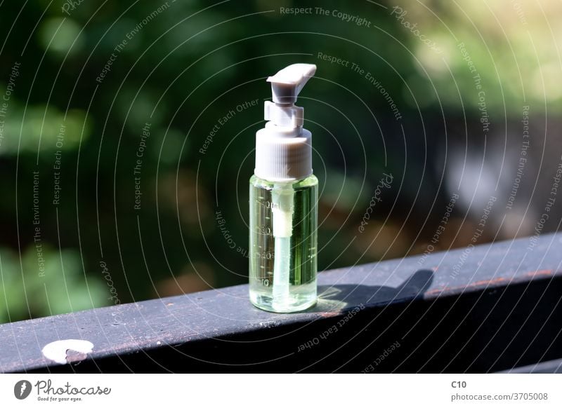 Hand sanitizer bottle on a windows sill alcohol alcohol gel background care clean closeup container coronavirus cosmetic covid-19 disinfect glass green hand