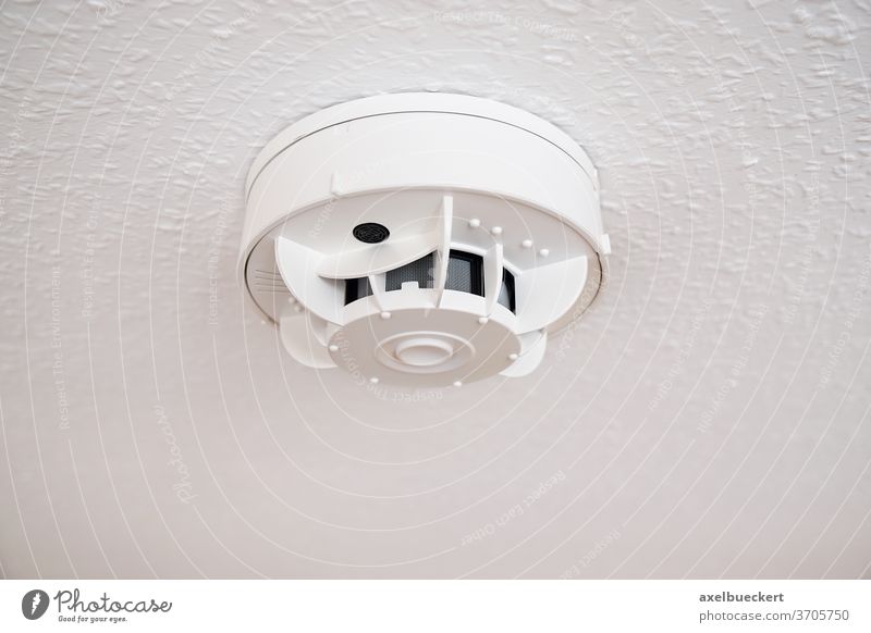 smoke alarm or detector fire ceiling sensor protection prevention safety security home household white system domestic equipment technology object room interior