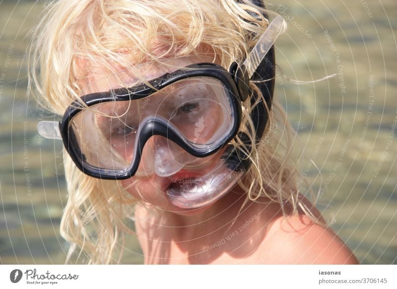 Child with diving goggles and snorkel at the sea on holiday vacation Snorkeling Diving goggles Infancy snorkel mask Vacation mood coronavirus Corona virus