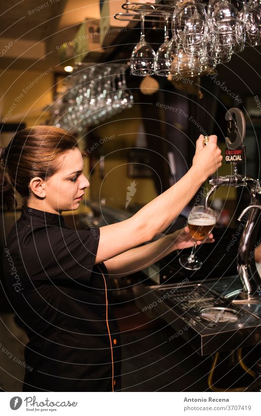 Waitress tapping faucet beer in bar waitress pub woman 30-35 years Adults Alcohol Andalusia Bar Bartender Beer Glass Caucasian Color Image Dishes Drink