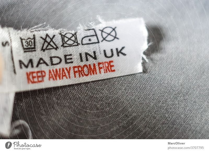 Made in UK made in uk keep away from fire shirt label clothing label sign text letters Warning label Warning sign Signs and labeling
