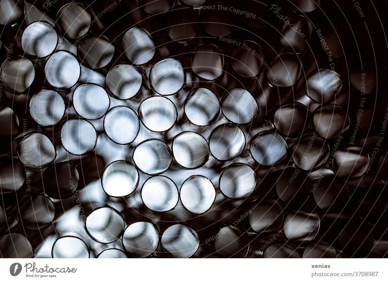 Light shines through many culms, but some remain dark circles Drinking straws Digital Many Bright Dark moody Plastic Structures and shapes Round Abstract Pipe