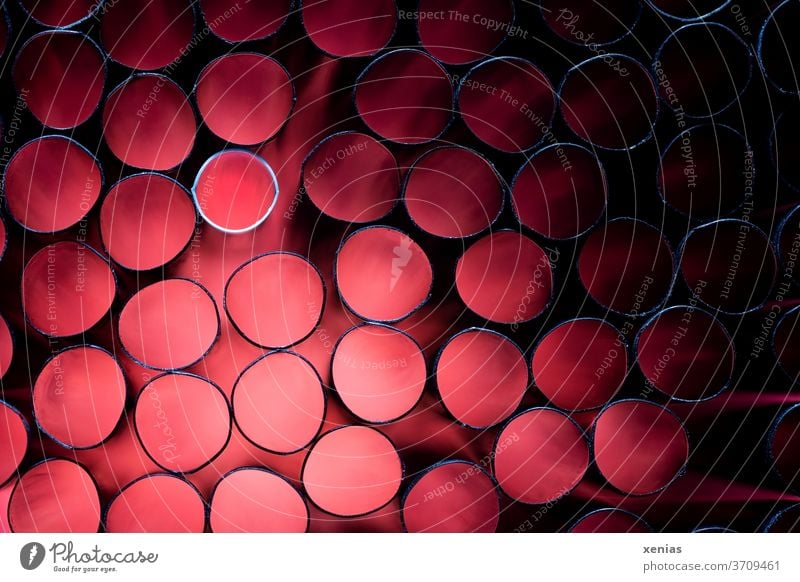 Many black and one white straw with red light Red Straw pipes Black White Ring Shallow depth of field Artificial light Studio shot Plastic Round Light