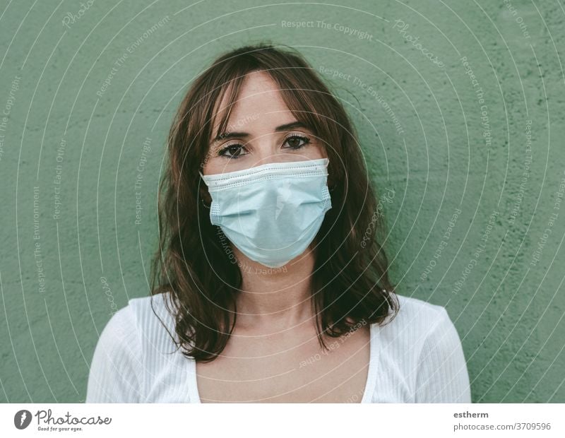 Close-up of young woman wearing medical mask coronavirus epidemic pandemic quarantine covid-19 symptom medicine health background blur positive test hospital