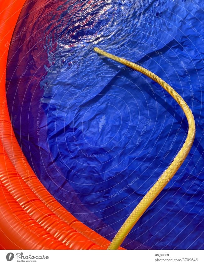 Fill the pool with water using the garden hose Water Paddling pool Yellow Blue Orange woman Wet Design Reflection Summer Colour photo Swimming pool
