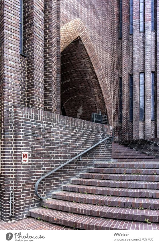 A staircase leads to the beautiful portal of the church Church stagger Entrance Stairs Brick Portal Disability friendly barrier-free obstacle Detour