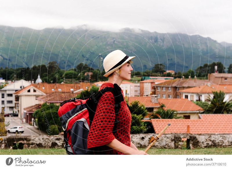 Traveling woman with backpack standing near old town pilgrimage hike travel spain activity architecture mountain camino de santiago female asturias llanes