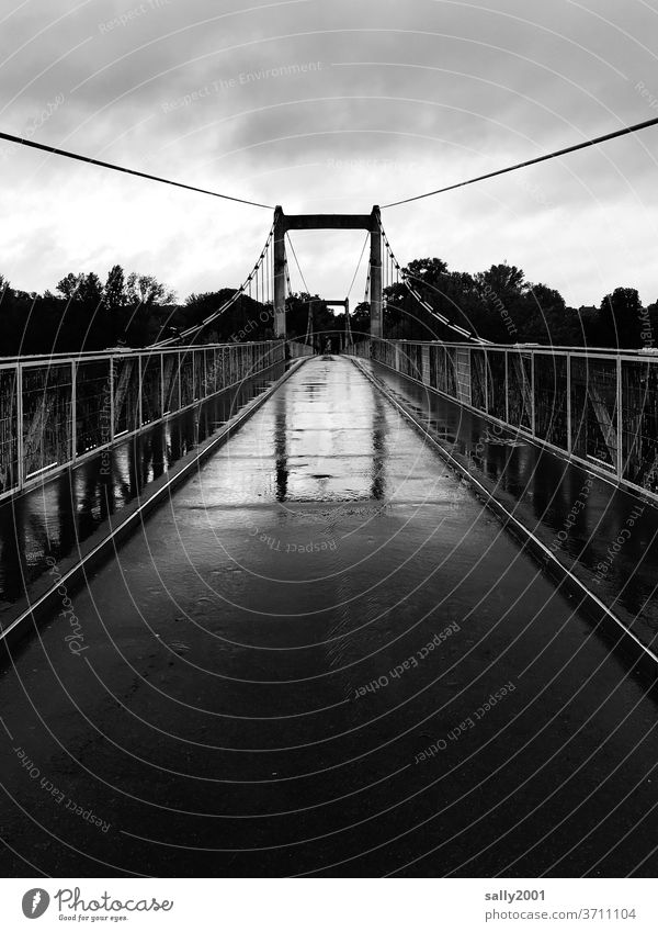 Bridge in the rain... bridge Rain Narrow Pedestrian bridge Handrail Suspension bridge Asphalt Bad weather Wet Black & white photo reflection Reflection