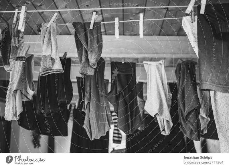 Laundry on the line in a carport House (Residential Structure) staples Clothes garments socks Dry Clothesline out hang black-and-white Wash Washing Washing day
