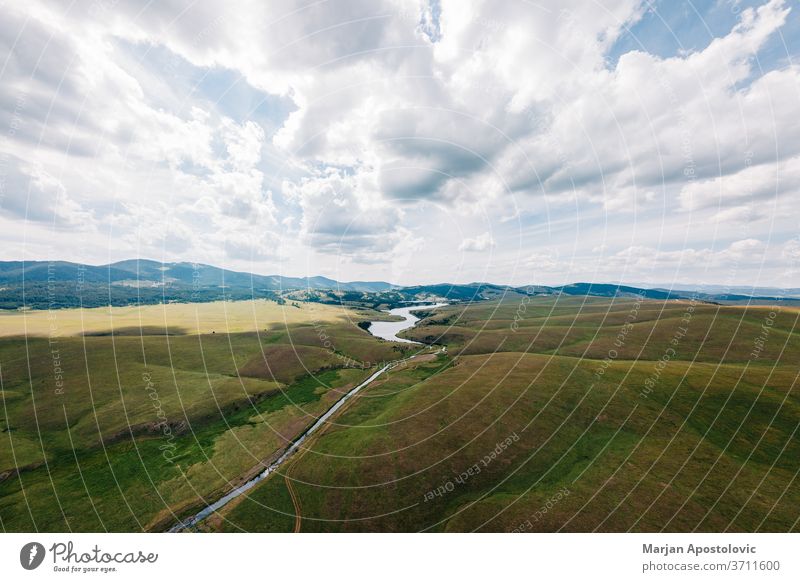 Aerial view of a Ribnicko lake in Zlatibor, Serbia above aerial background beautiful cloud clouds country countryside day environment europe field flying grass