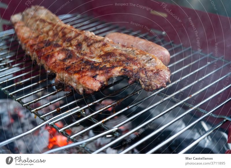 Pork ribs grilled over the coals. Concept of food. Copy space. charcoal pork roast fire embers seasoning celebration restaurant friends family enjoy rib strip