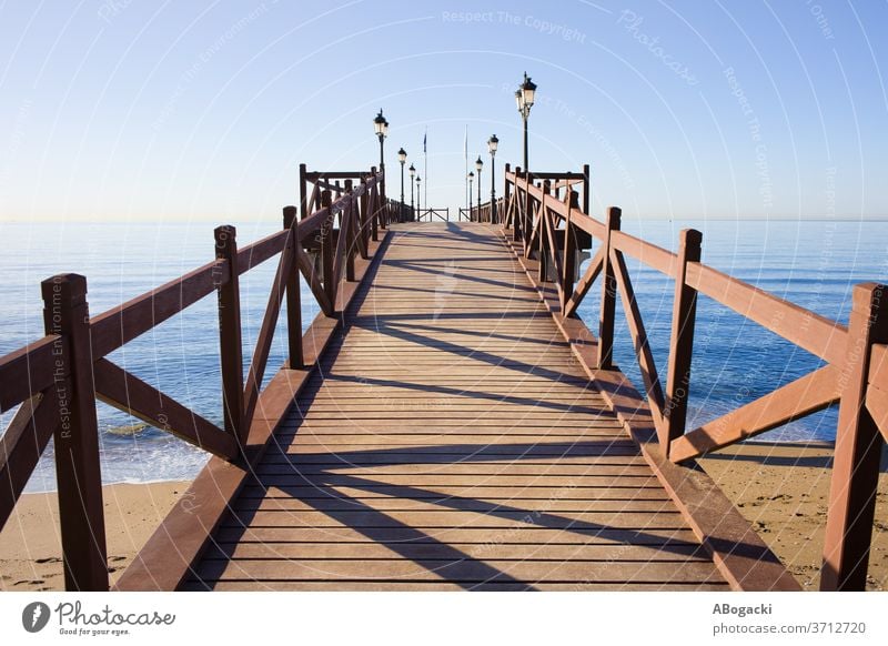 Pier on Costa del Sol in Marbella, Spain pier jetty sea wooden structure costa del sol spain marbella ocean water beach outdoor nature mediterranean sea