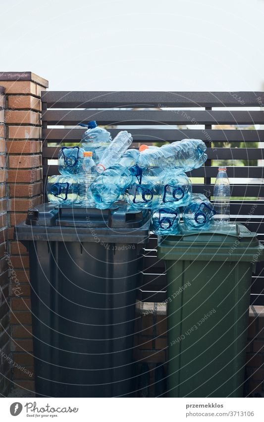 Disposal containers with empty used plastic water bottles on the top. Collecting plastic waste to recycling. Concept of plastic pollution and too many plastic waste. Environmental issue