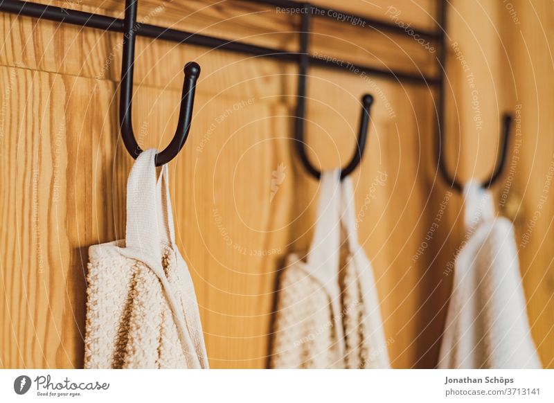 white towels on a hook on a wooden door Bathroom bathroom Vacation home Checkmark Towel hook Towels Wooden door Hotel Interior shot Dry Flat (apartment) at home