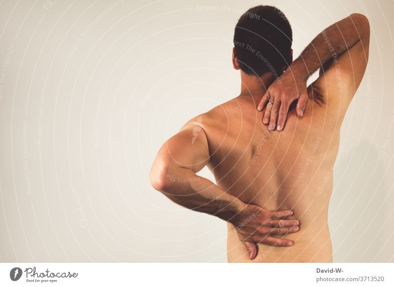 Man with back pain Back pain Pain Human being Colour photo Healthy Health care Adults Spinal column by hand Hurt Therapy Slipped disc intervertebral disc Stress