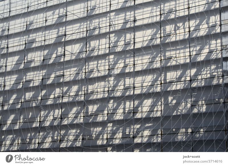 Anticipation arises, behind the scaffolding Scaffold Shadow play Structures and shapes scaffold tarpaulin Sunlight Symmetry transparent Silhouette Aspire