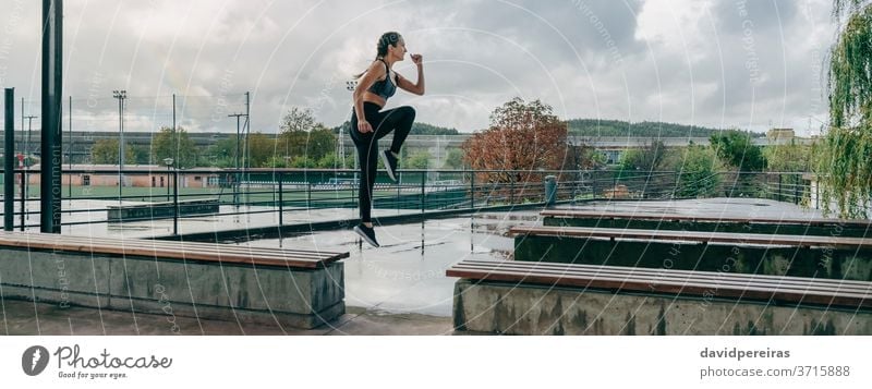 Girl jumping on benches doing training rainy sport girl energy empowerment style body boxer braids fitness banner web panoramic panorama health healthy exercise